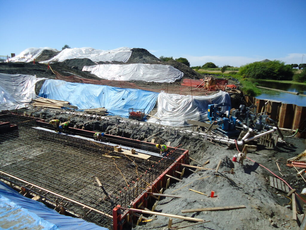 Images demonstrating groundwater dewatering techniques, showcasing the use of pumps and equipment to effectively manage and lower groundwater levels at construction and mining sites for safe and efficient operations.